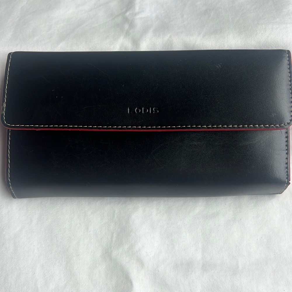Lodis black leather wallet with white stitching and red interior.